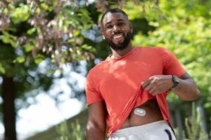 A man wearing a continuous glucose monitor.