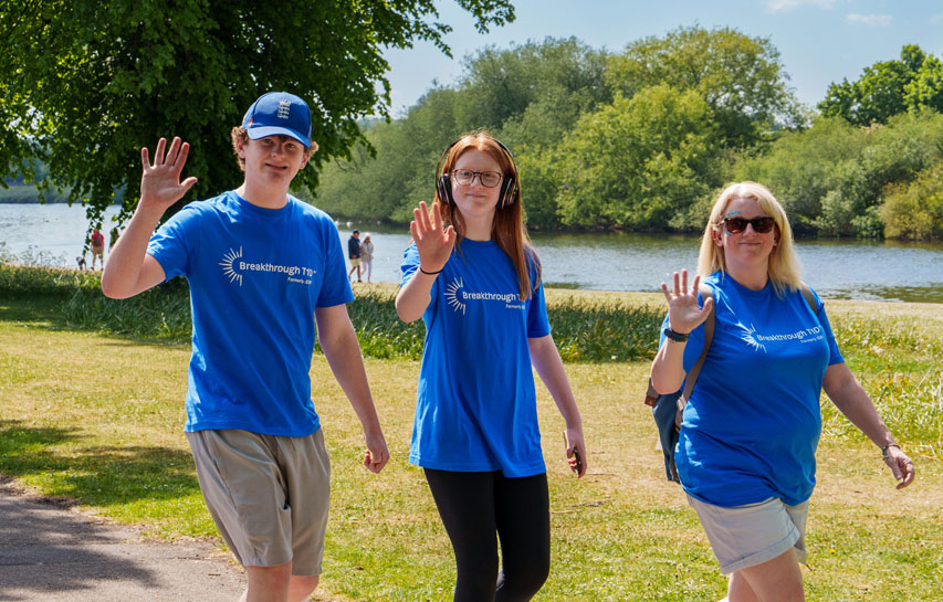 Family of three people in a park on a Breakthrough T1D One Walk raising money for type 1 diabetes.