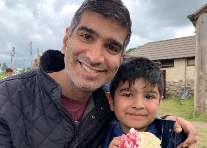 A photo of a man, Sheraz Nazir, with his arm around his son, Aadil