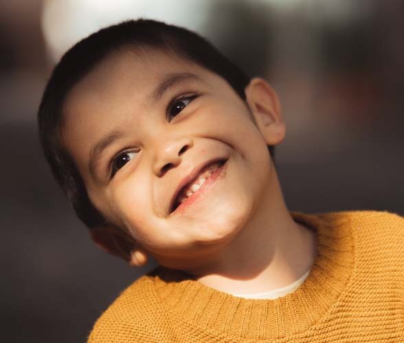 Smiling child in yellow jumper