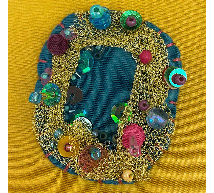 Embroidered cells on a Megan Neville bag for her project Ordinary Oddness.