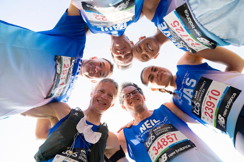 London Marathon 2025 group in breakthrough t1d running vests looking down at camera