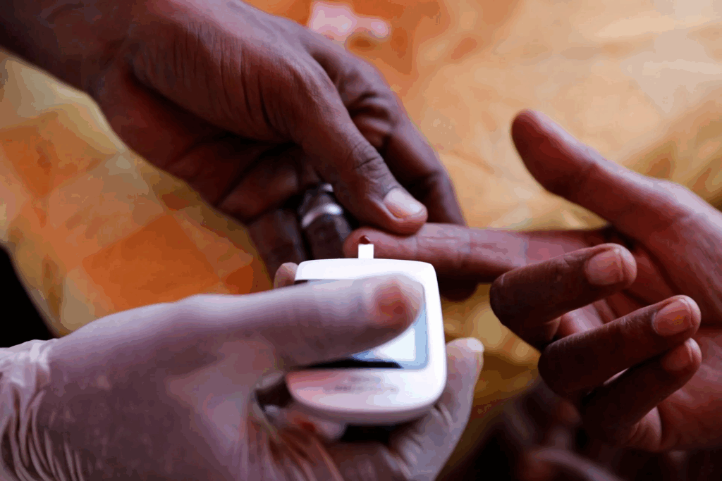 Image showing blood glucose testing using blood glucose monitor in Africa.