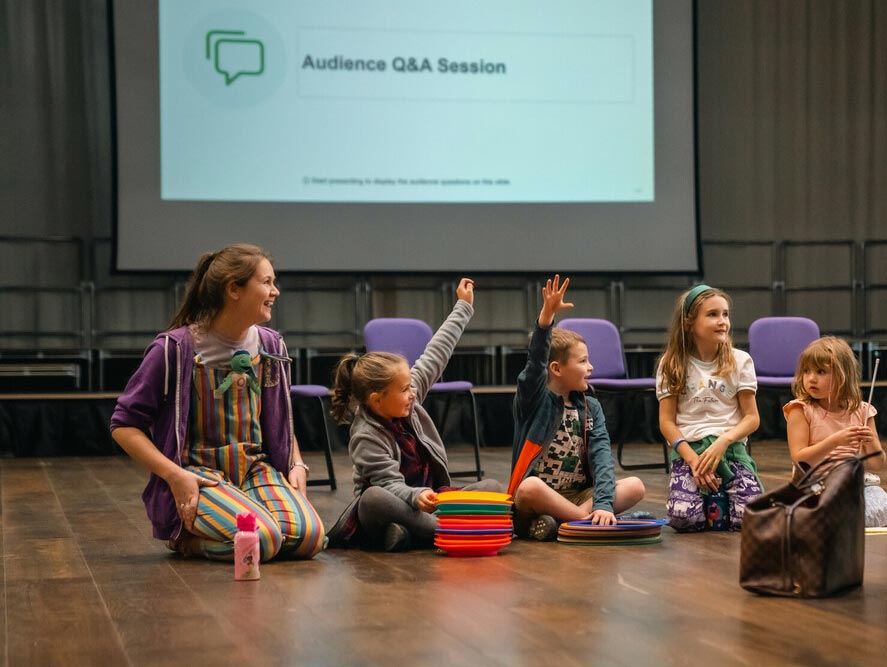Children seated on floor at a Discovery Day Q&A session