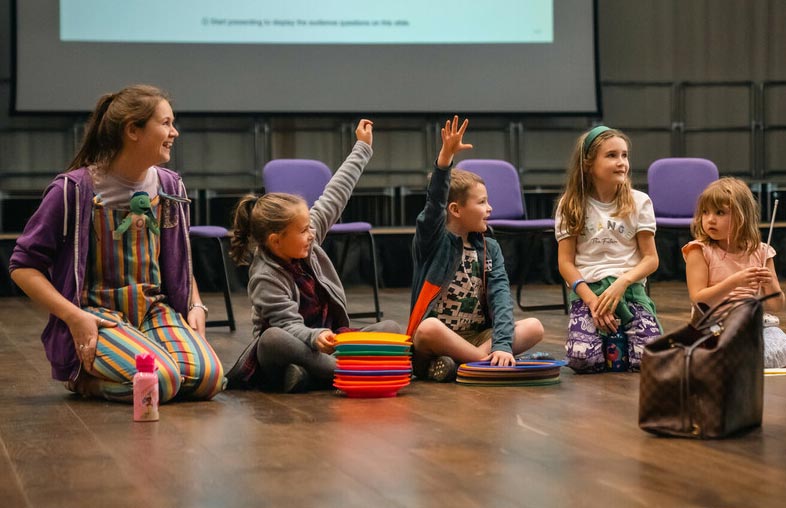 Children seated on floor at a Discovery Day Q&A session