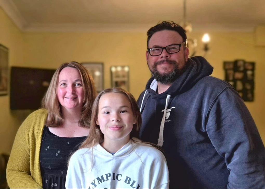 Image showing mother, daughter and father smiling at the camera.