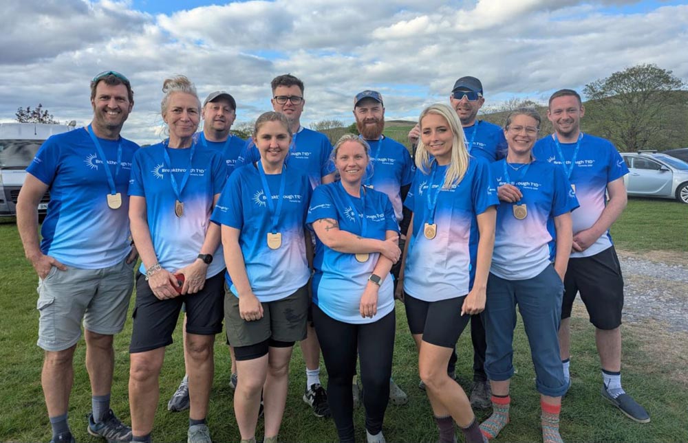 Group shot of Breakthrough T1D Yorkshire Three Peaks 2025 participants with medals