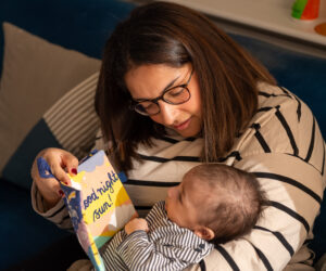 Manisha reading to her newborn son, Dillan