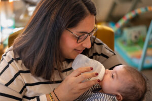 A photo of Manisha feeding her newborn son