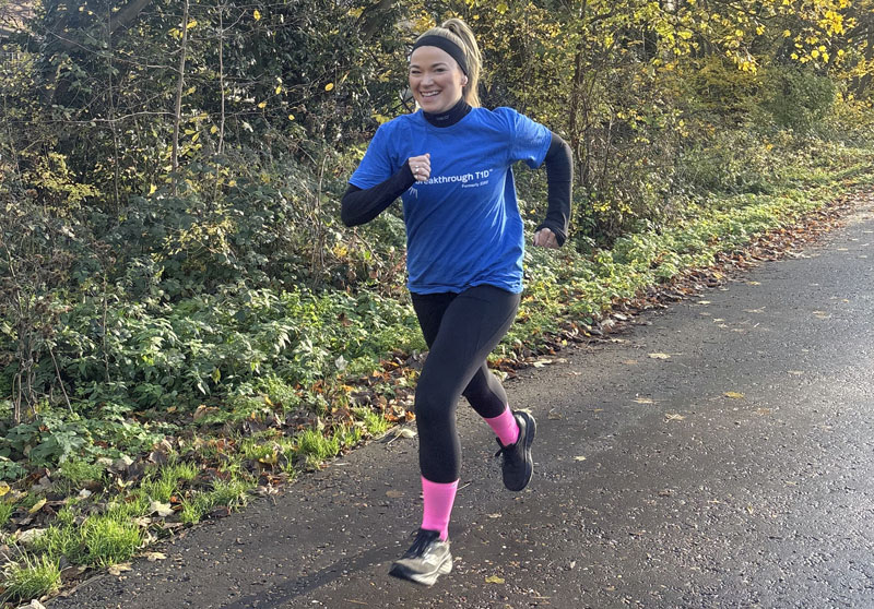 Woman running along path in Breakthrough T1D outfit to raise money for February Run Challenge