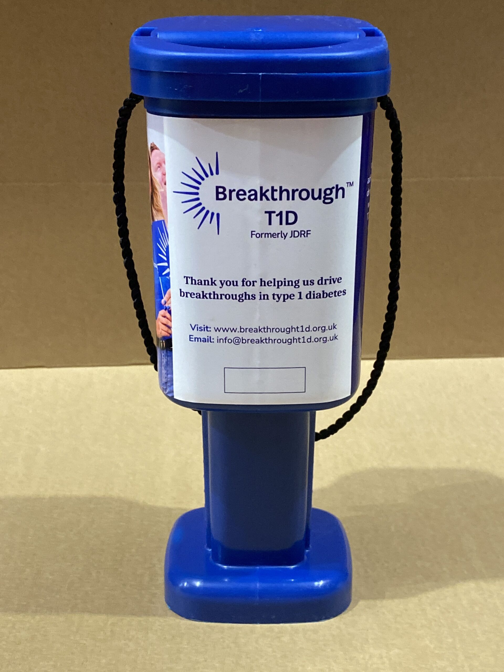 A blue collection tin with the words 'Breakthrough T1D - thank you for helping us drive breakthroughs in type 1 diabetes'