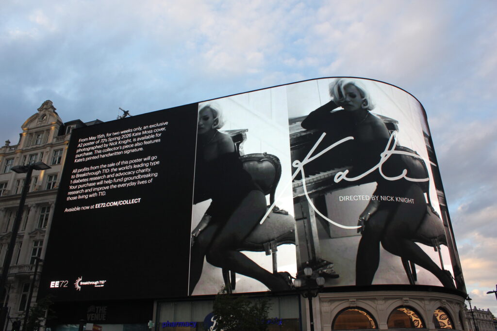 A black and white image of Kate Moss, alongside the Breakthrough T1D logo on Piccadilly Lights