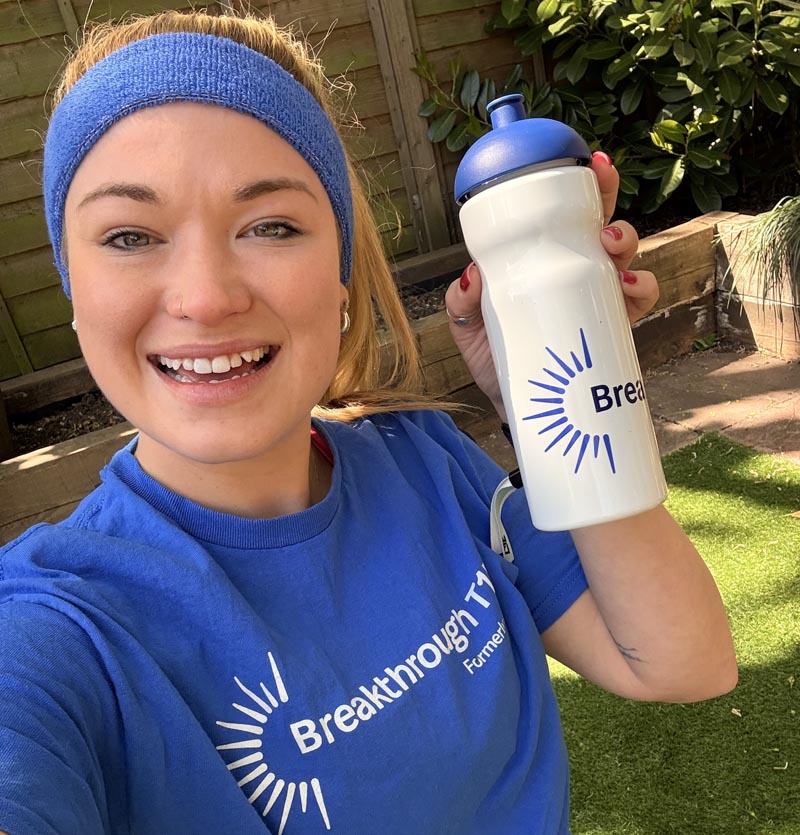 Young woman holding Breakthrough T1D water bottle