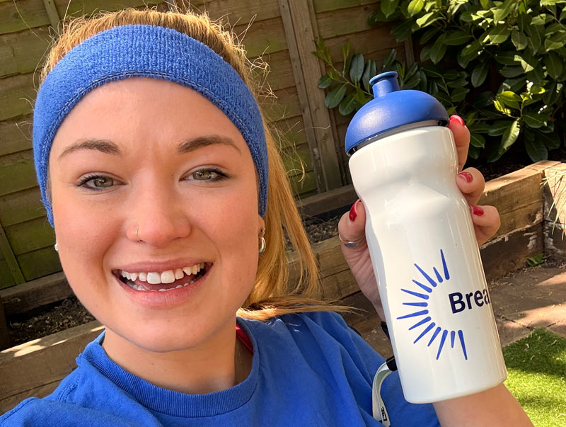 Young woman wearing Breakthrough T1D headband and holding water bottle