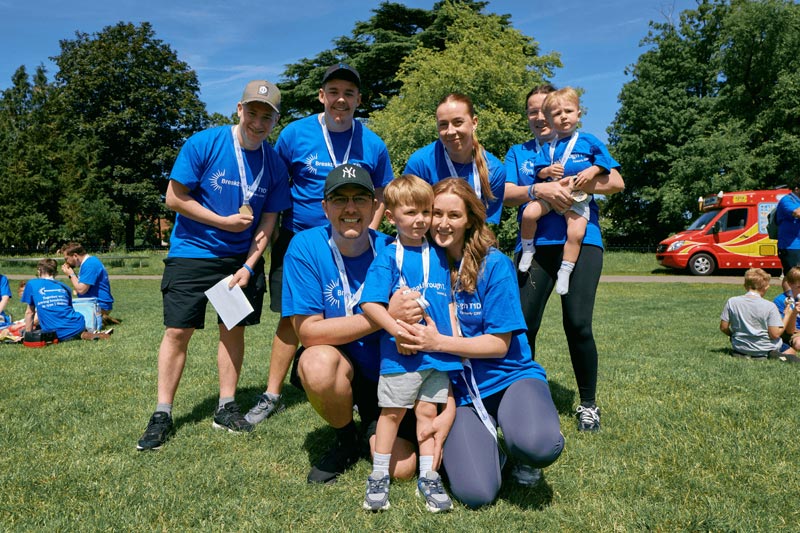 A family group posing in the park while taking part in Breakthrough T1D's One Walk Bristol to raise money for type 1 diabetes